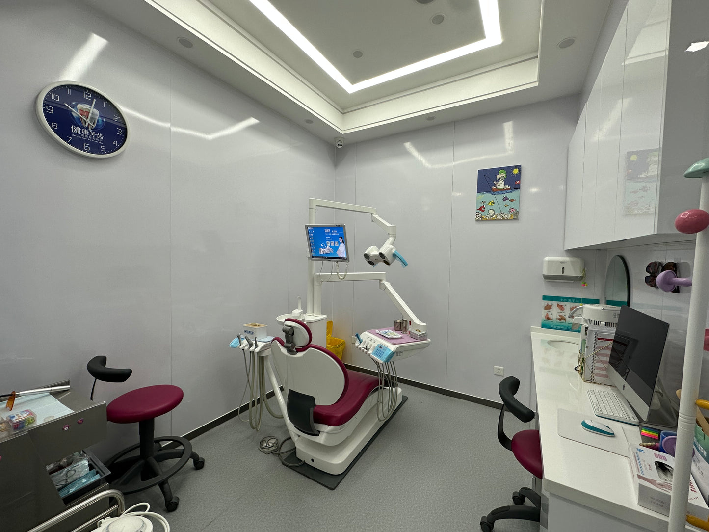 Dental treatment room with patient chair and chairside monitor