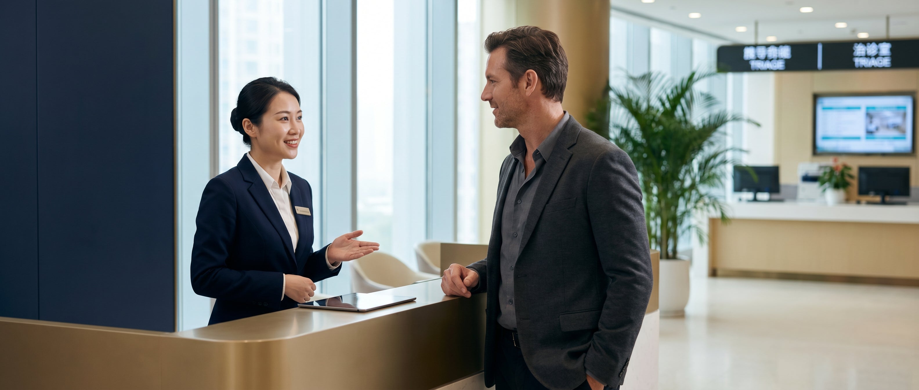 Bilingual concierge welcoming a Western patient at a Chinese Grade 3A hospital VIP health screening reception